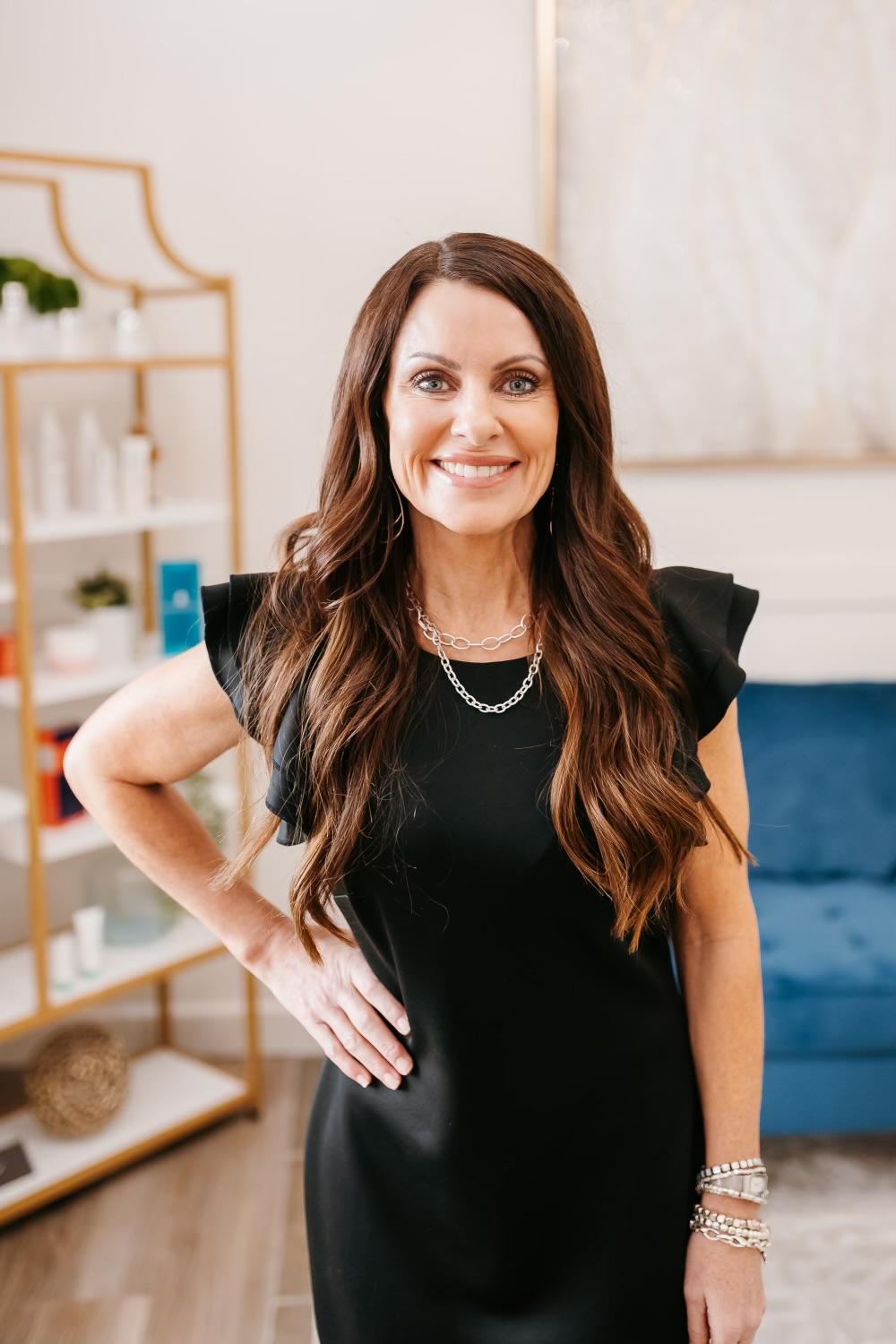 Ridgeline provider in a black dress smiling in the clinic