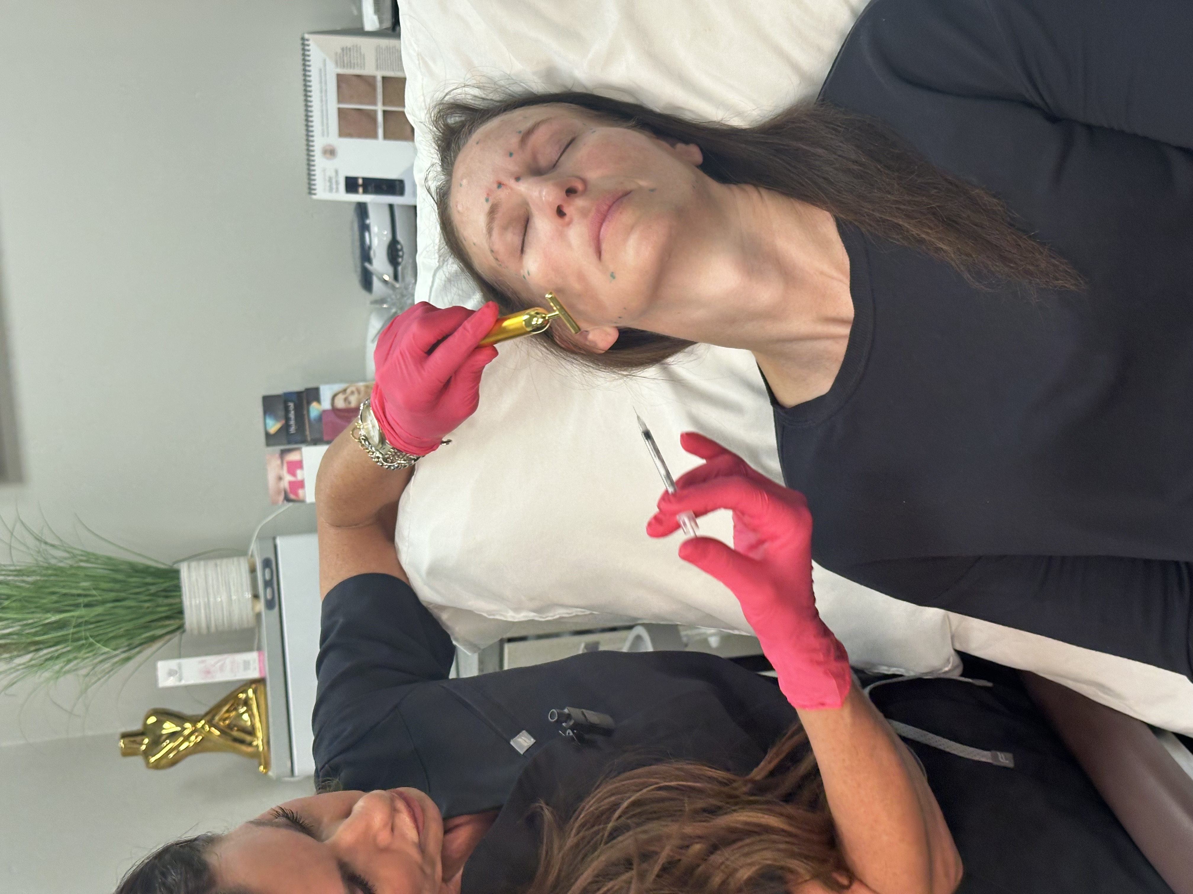 Provider performing a facial injectable procedure in a treatment room