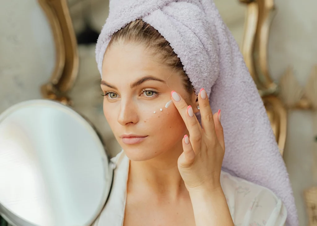 woman applying moisturizer after micro-needling treatment